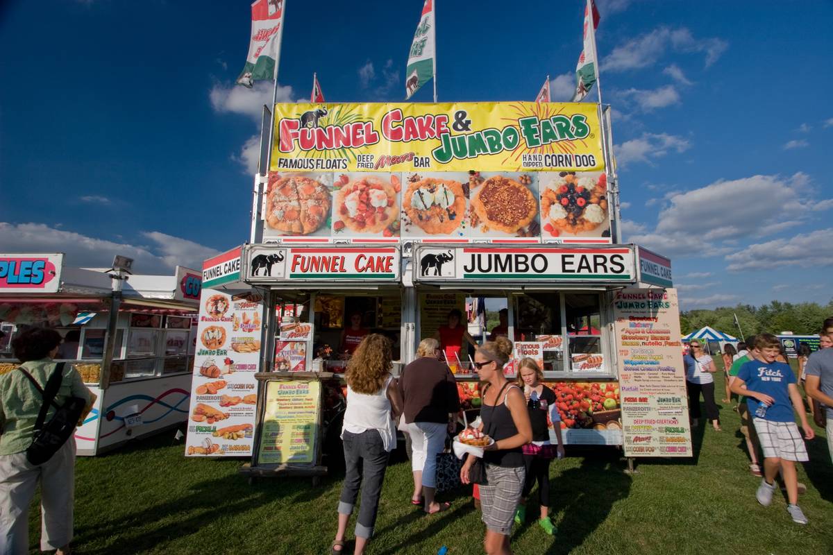 A vendor at the ribfest, serving fried everything topped with sweet anything