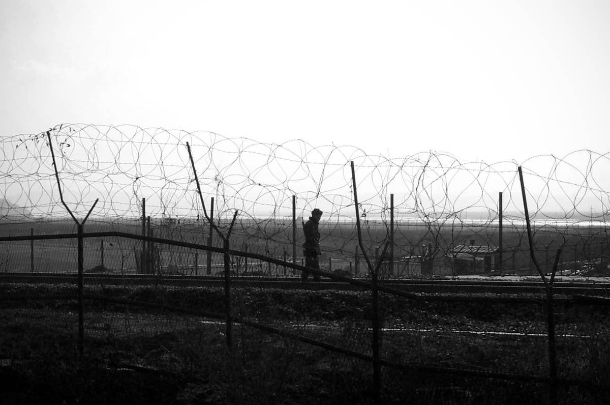 A soldier patrols a railway that leads to Pyongyang from Seoul