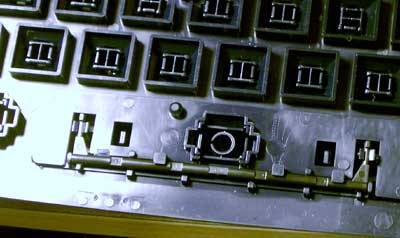A rod behind the space key ensuring even presure throughout the span of the key