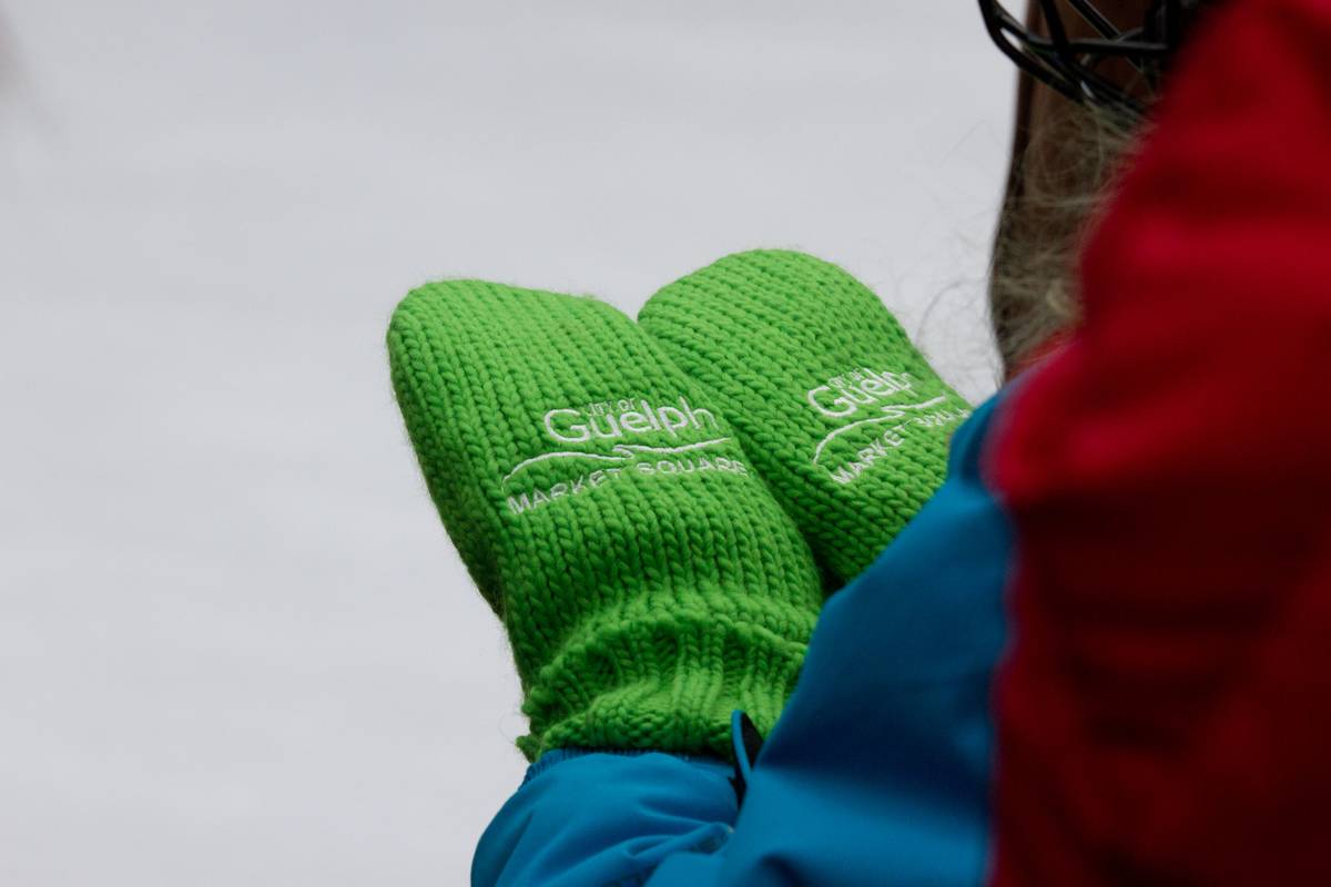 A girl checks out the complimentary mittens she received for contributing to the fundraising efforts, also known as the 