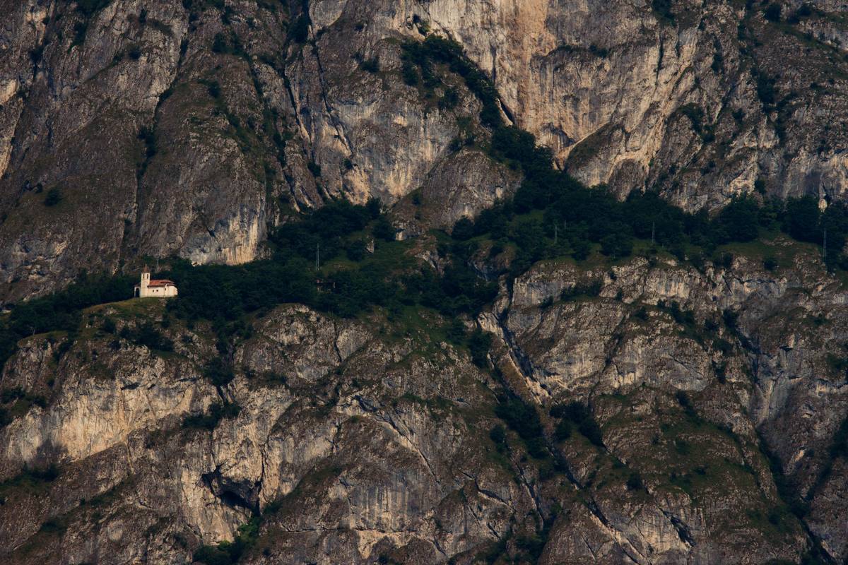 A building resembling a chapel sits atop the slopes of Cadenabbia, viewed across the lake from Bellagio.