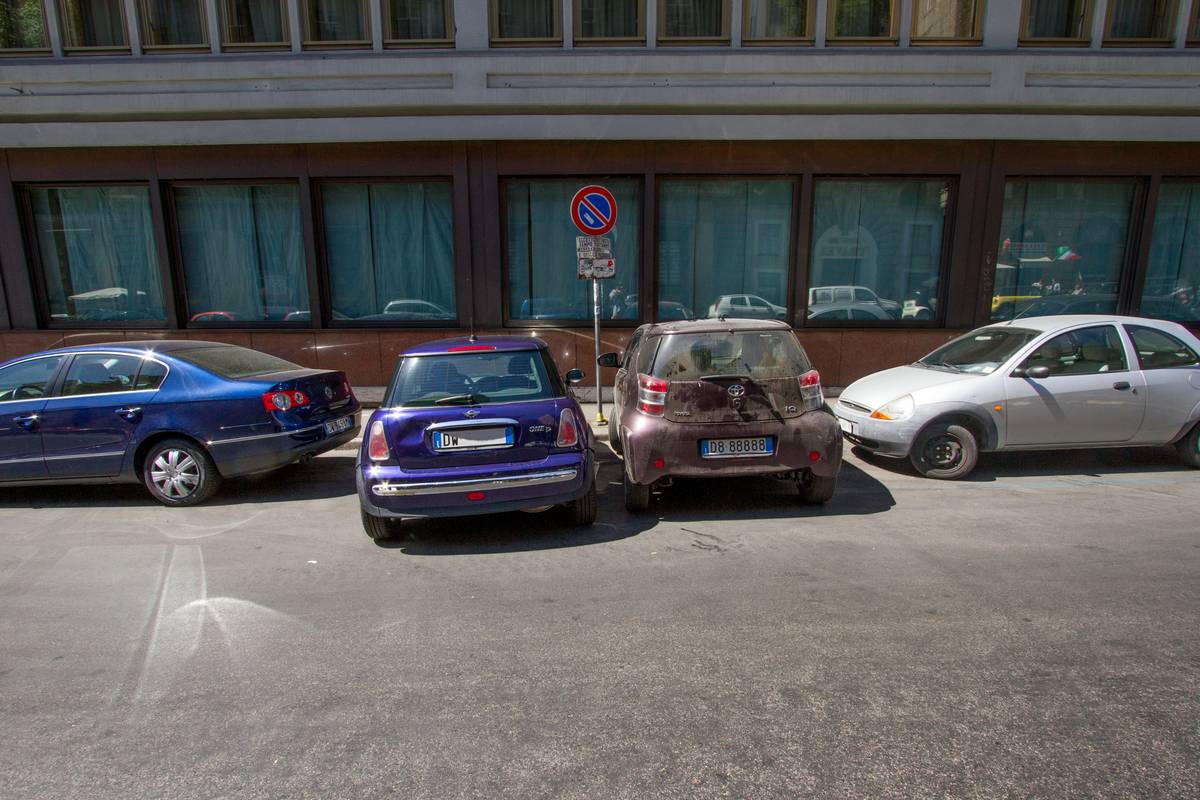 A typical street parking etiquette in Rome