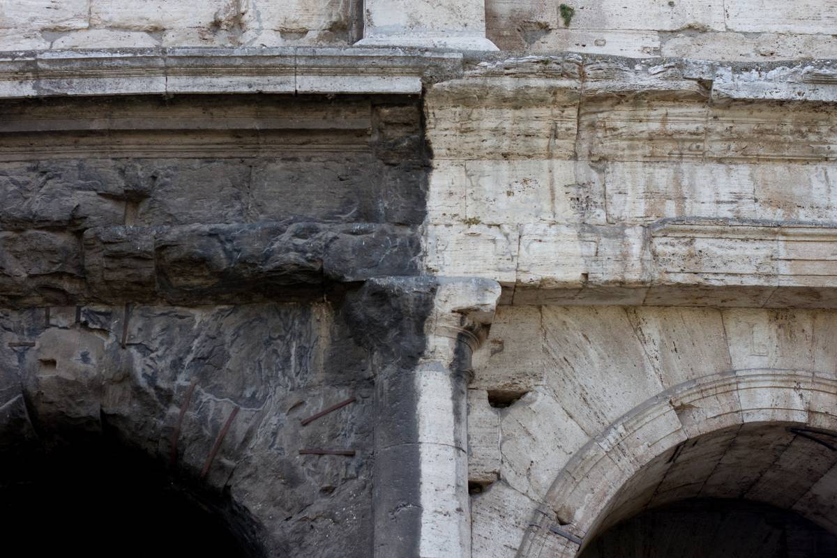A clear demarcation can be seen on this detail of the façade.  To the left, decades of soot from automobile emissions have completely blackened the surface while the original, though weathered, white marble can be seen on the right