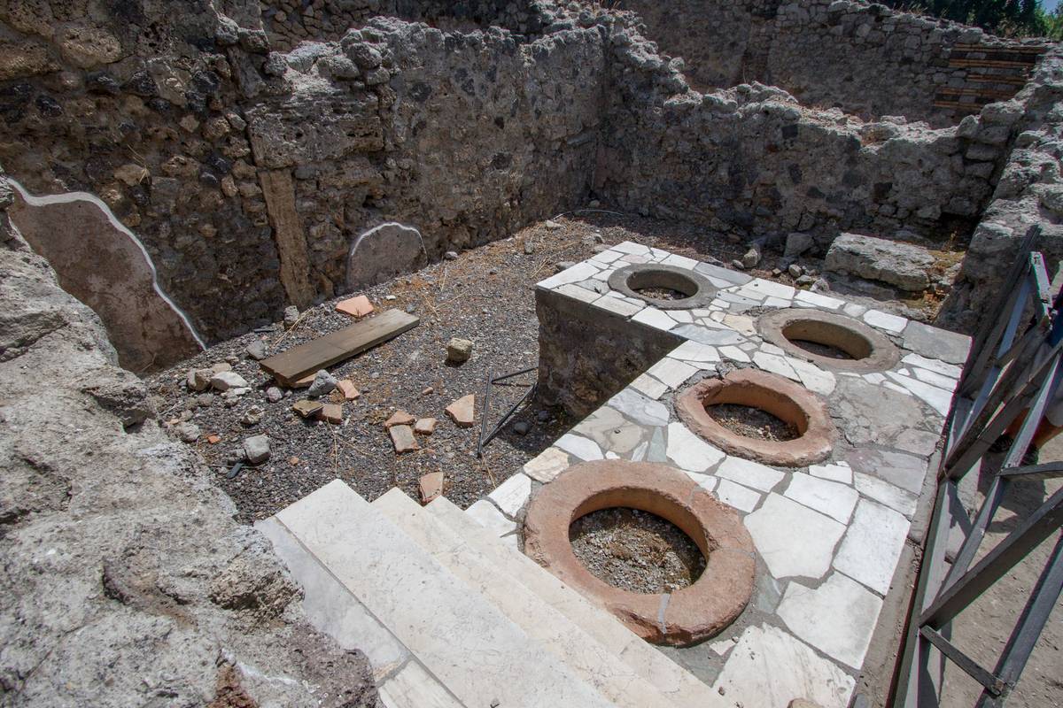 Terracotta containers serving hot “fast” food in Pompeii’s many *thermopolia*