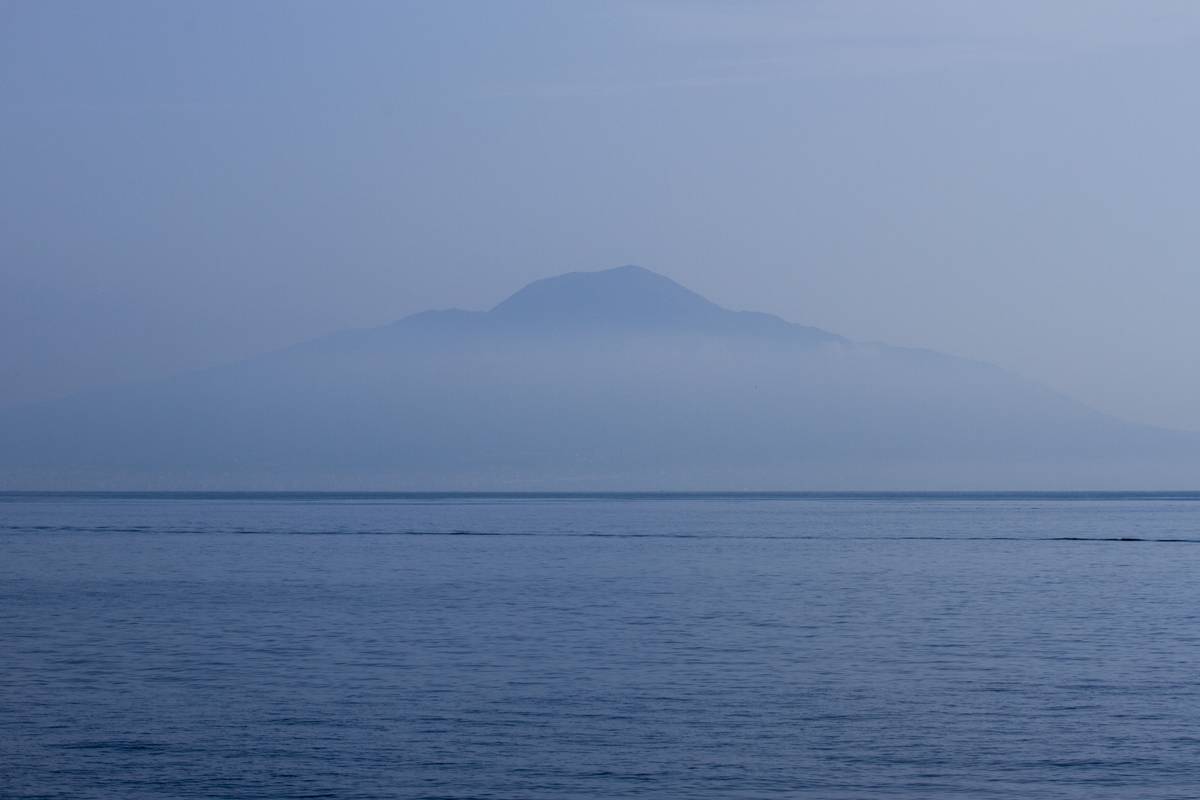 Mount Vesuvius from across the Bay of Naples poking through the morning fog