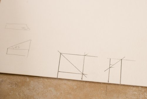 Homemade mini cardboard triangular set squares drawn
