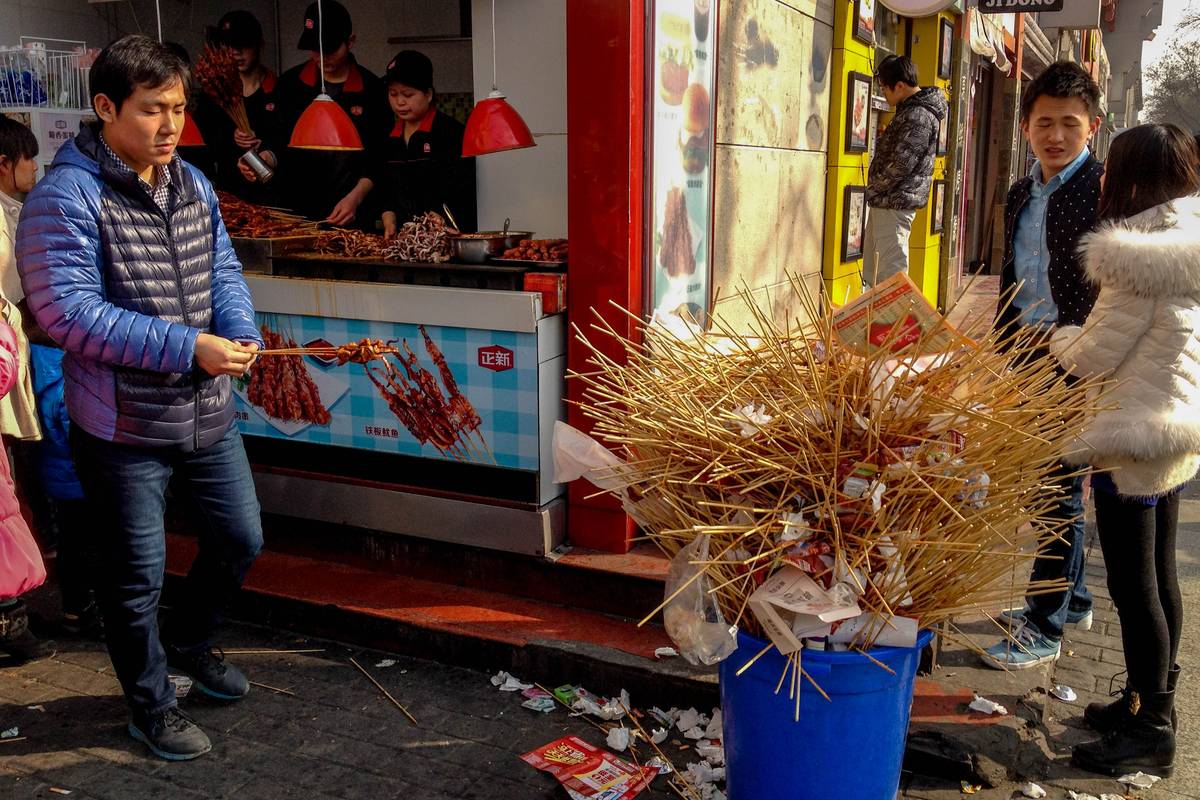 Spent meat skewers amassed over the day on the North Street.