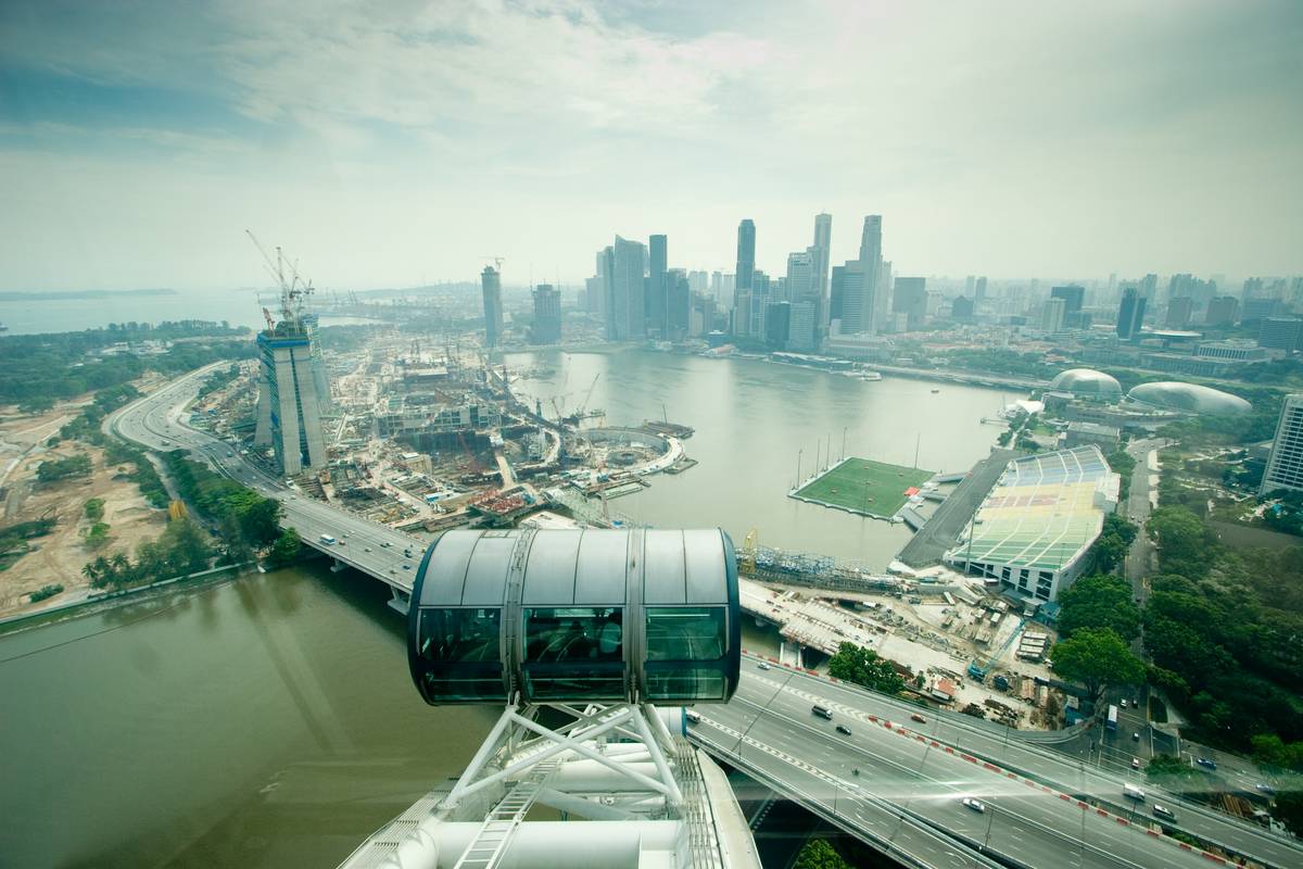 Singapore's Central Business District visible in a distance. [Marina Bay Sands](http://en.wikipedia.org/wiki/Marina_Bay_Sands) can be seen under construction towards the left.