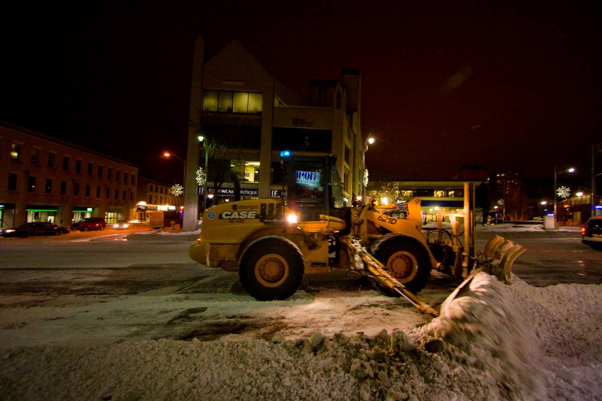 A snow plow clears the way for buses that gather here in St. George Square every 20 minutes