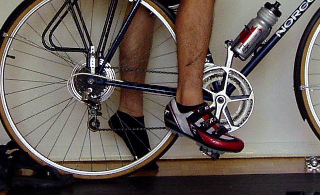 A height check on the saddle of a bike, photographing the angle of a foot at maximum down stroke, shoes clipped in