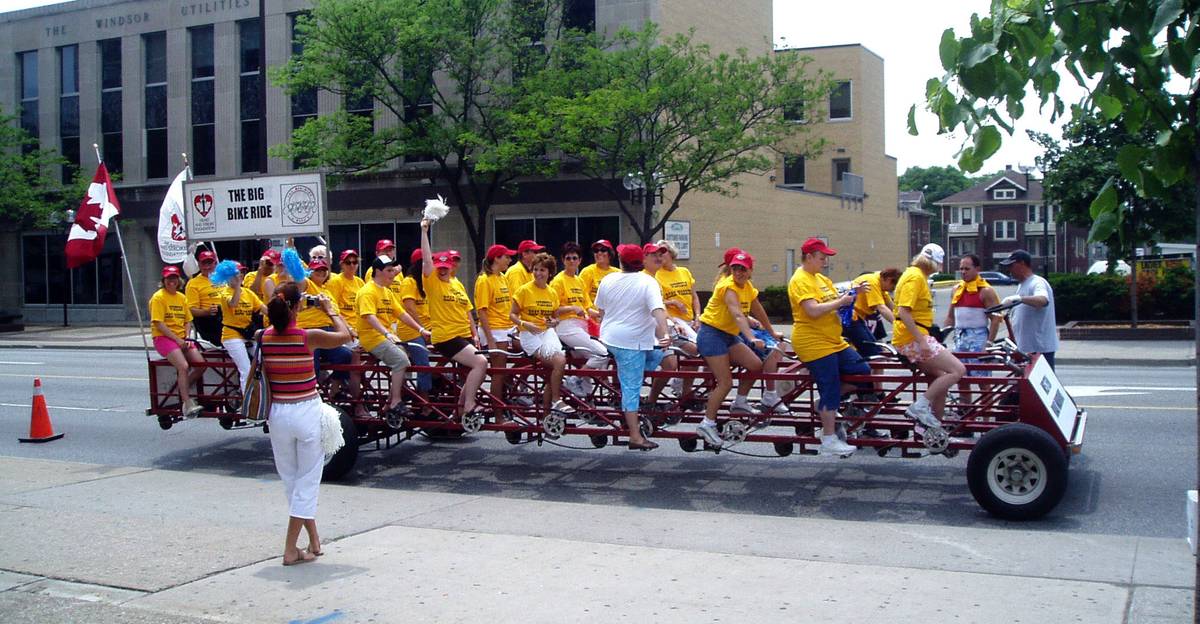 28 people seated on the Big Bike, ready for takeoff and race - and scream