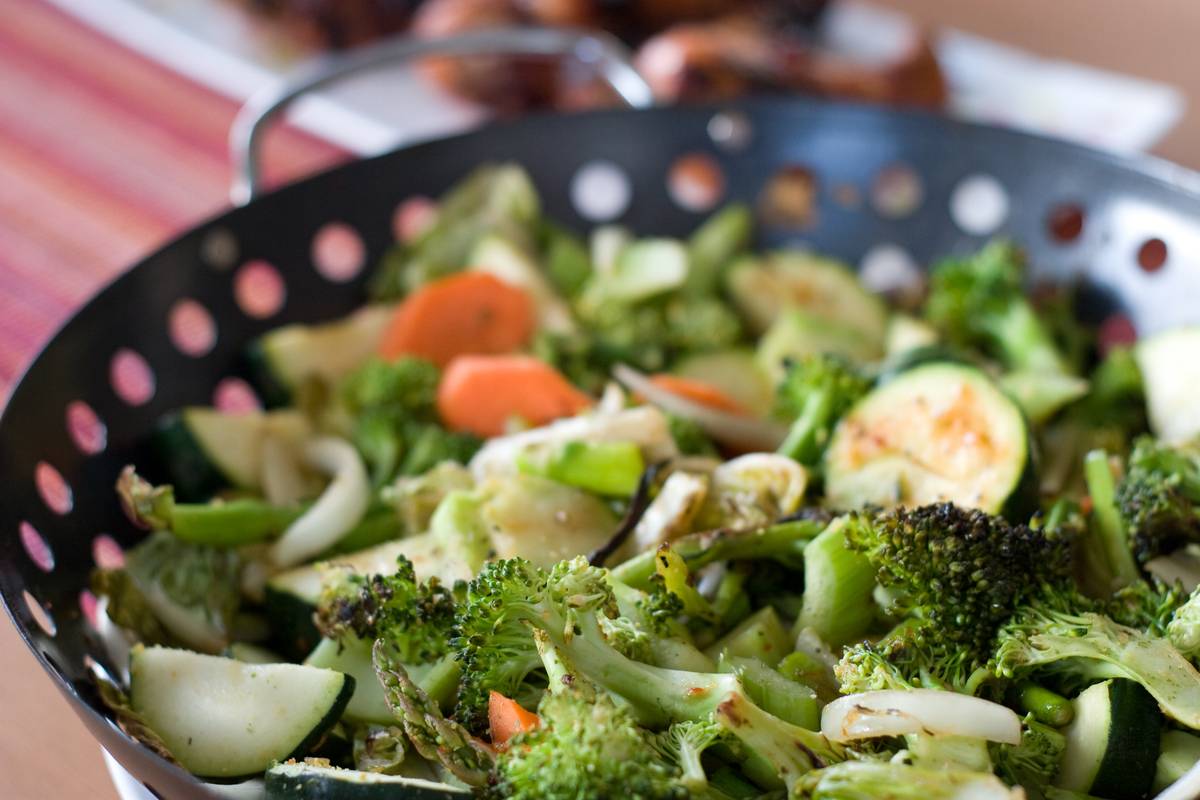 Zucchini, Romaine lettuce, carrots, broccoli, and other vegetables all rolled into a roasting wok, flavoured by the smoke of roasted chicken and salmon.