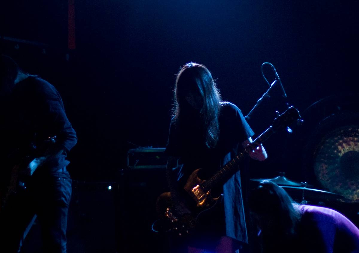 Tamaki Kunishi (bassist in Mono Japan) tuning her guitar after a performance by Maserati