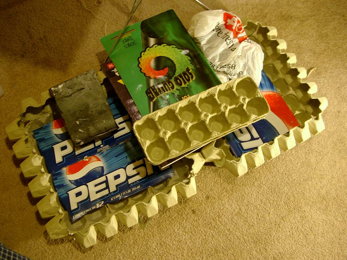 Two suitcase panels made out of egg trays stuck together using recycled materials