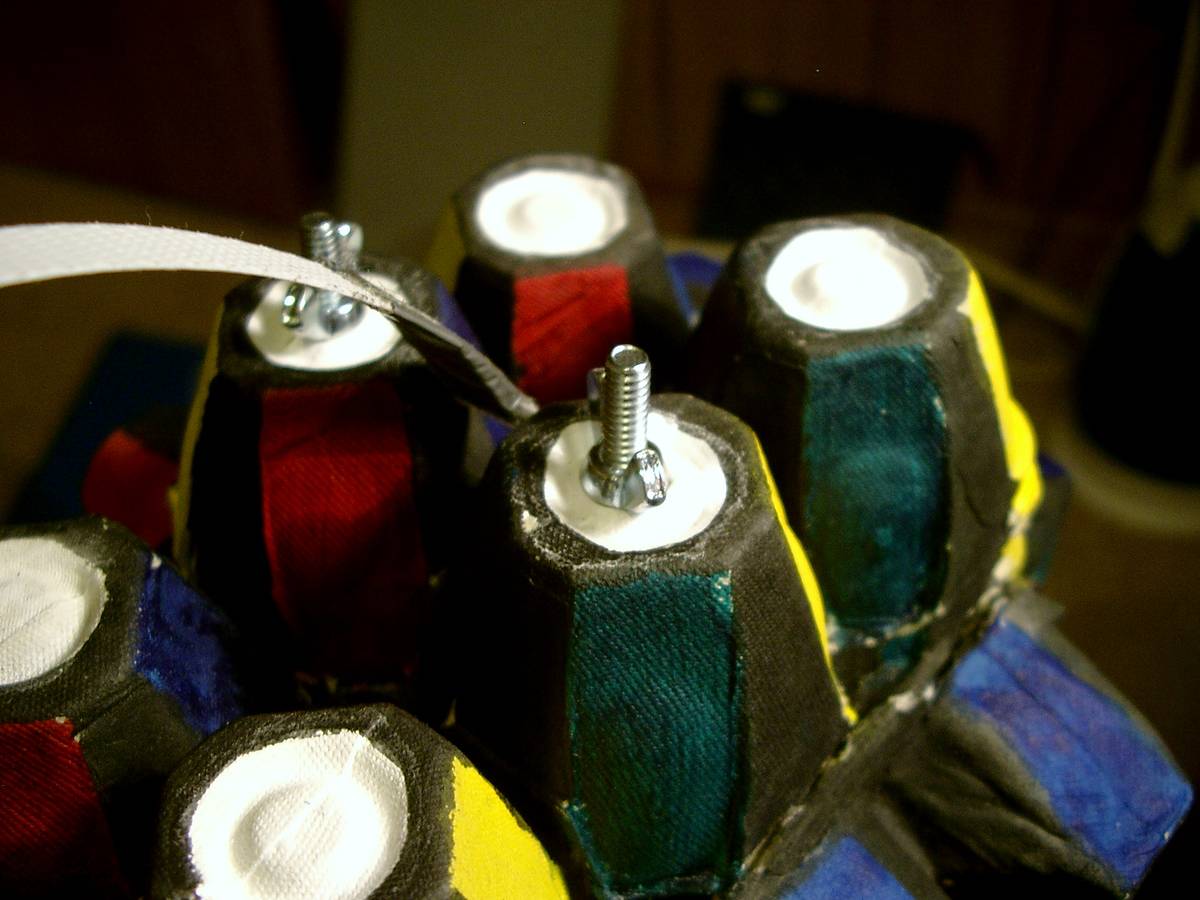 An egg tray stacks over the top part of the suitcase, creating a lock. Bolts hold the 