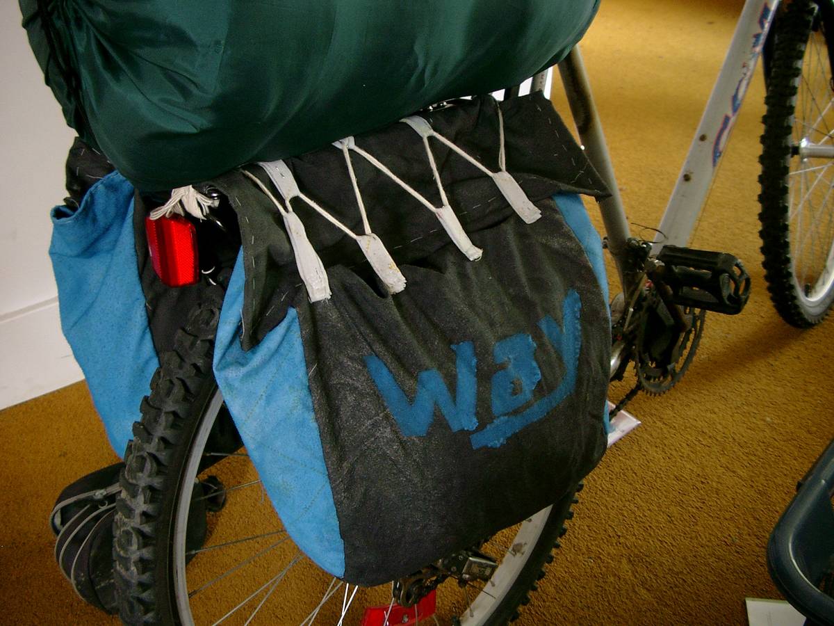 Bike panniers in action, with a sleeping bag on top