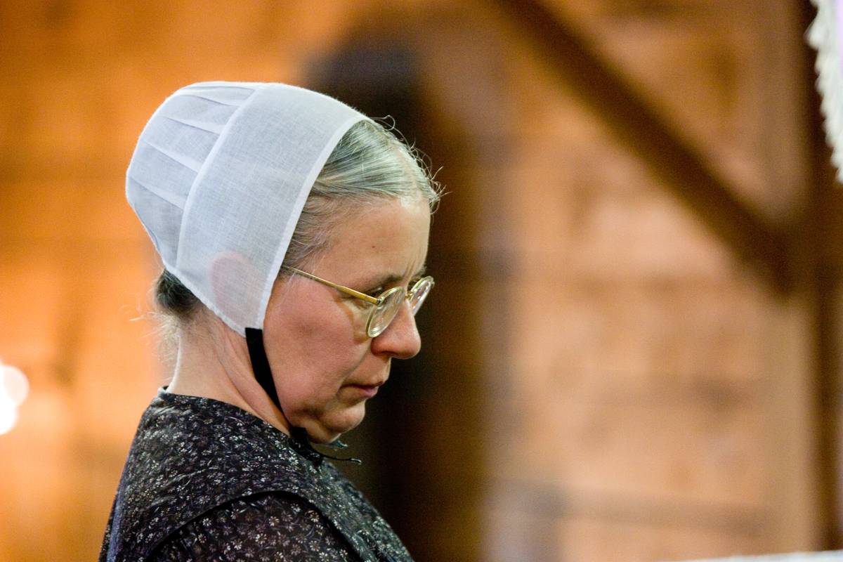 An Amish woman tends to her craft store.