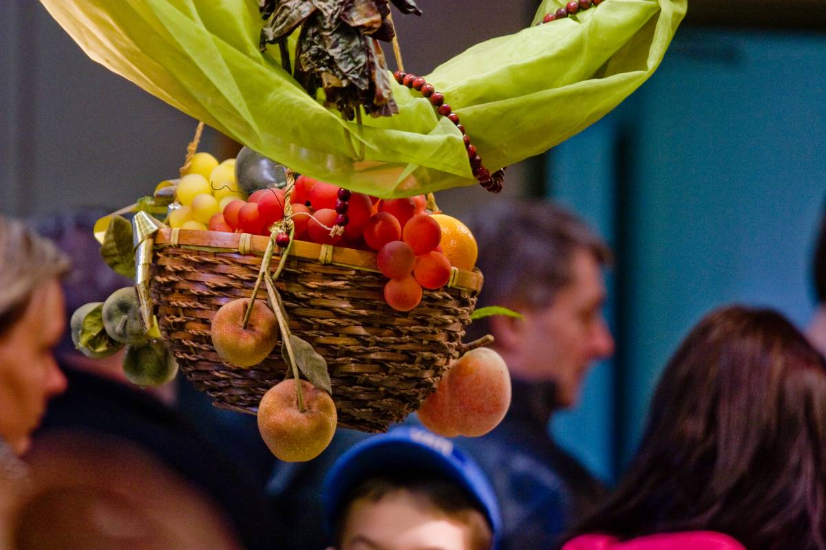 A decorative wicker basket accents the fruit stall.