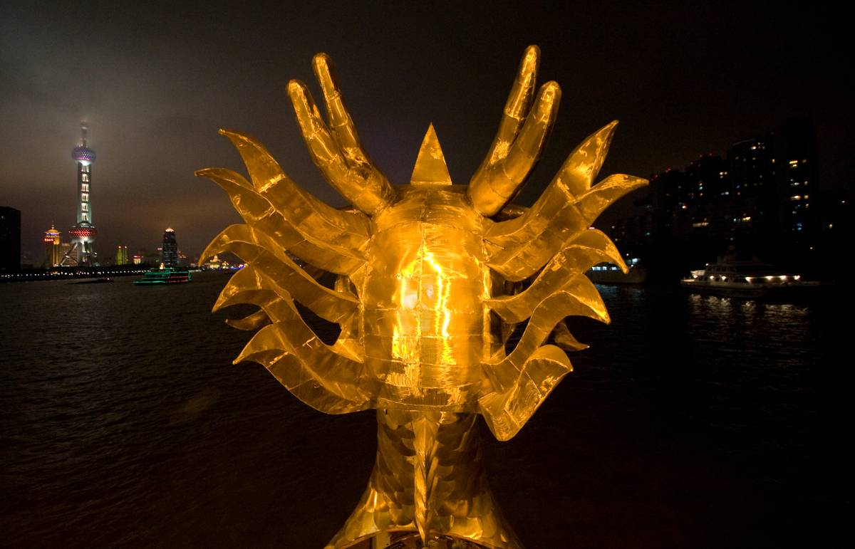 Behind a dragon's head on a night river cruise