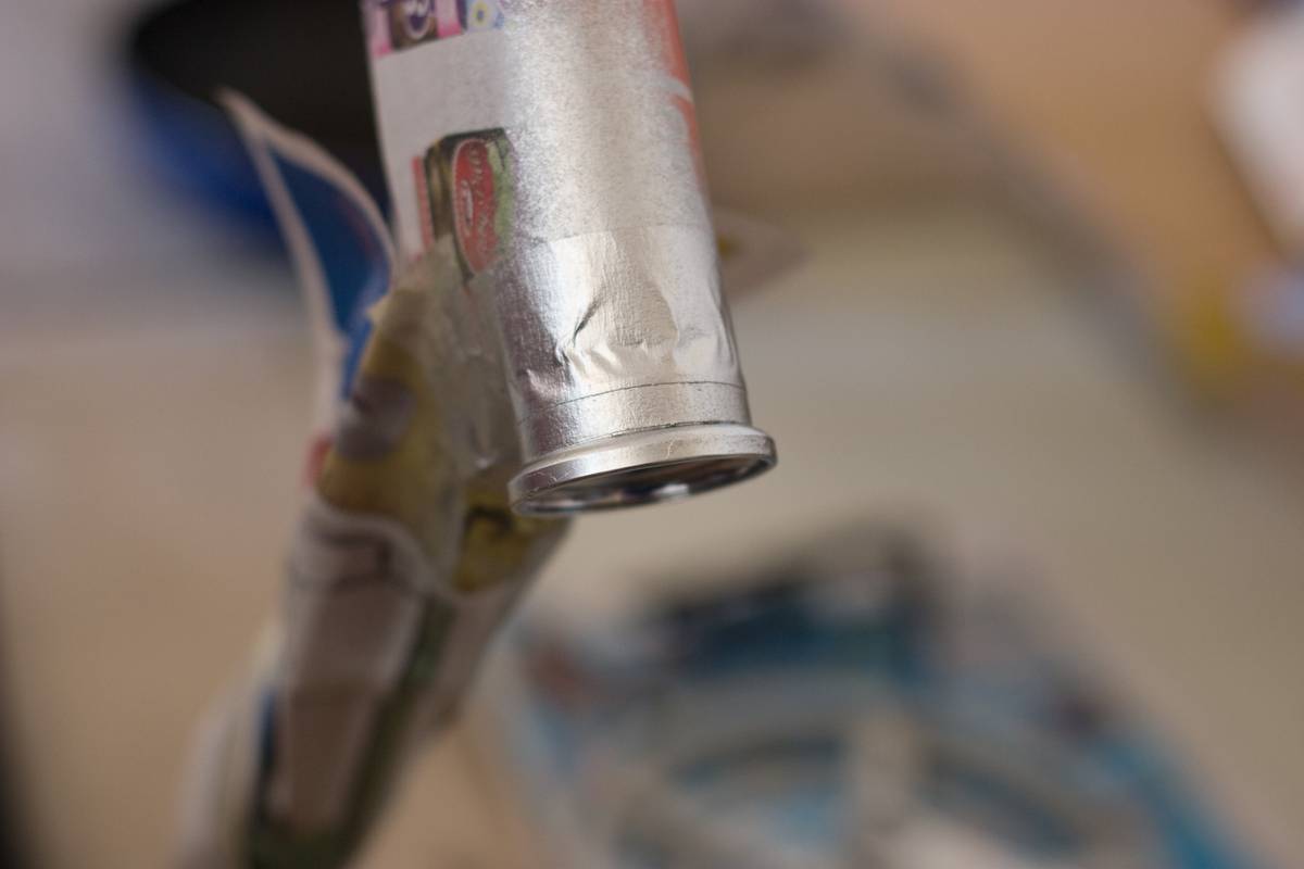 With the help of a piece of masking tape, I hoped to create a neat seam between the chrome paint and the black paint on the frame. Unfortunately, paint leaked under the masking tape
