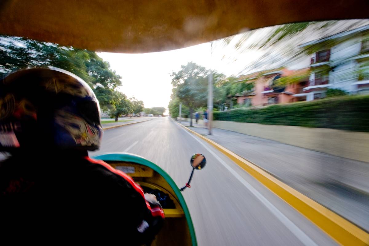 Traveling on a *coco taxi*, a yellow three-wheeled motorbike.