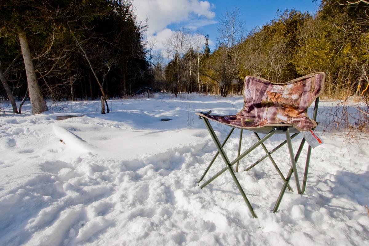 A foldable seat in snow in the middle of a jungle.